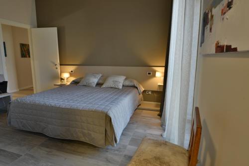 a bedroom with a bed with two pillows on it at Daman Rooms & Breakfast in Barzago