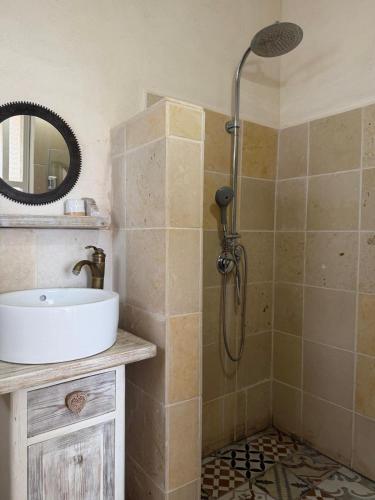 a bathroom with a sink and a shower at Benichuta in Mitzpe Hila