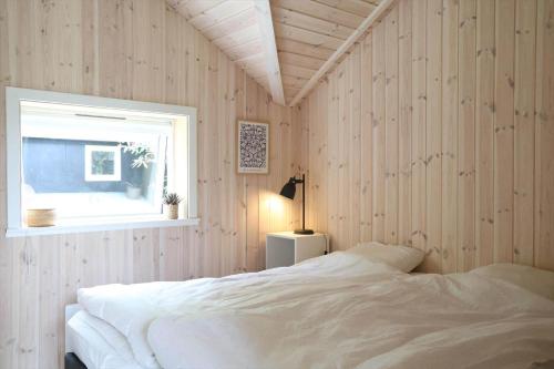 a bedroom with a white bed and a window at 11866-Nykobing-Sj-Skippervej-17 in Nyrup