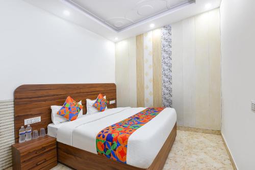 a bedroom with a large bed in a room at FabHotel Lotus Star in New Delhi