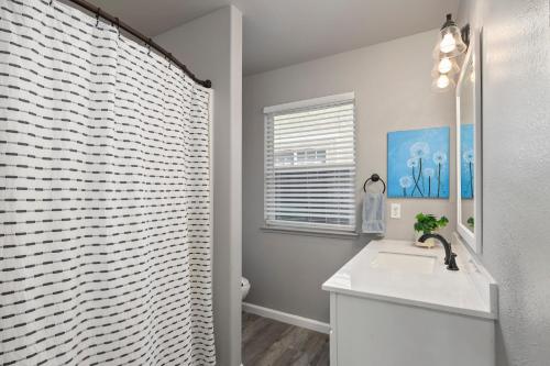 a bathroom with a white sink and a shower at Sunset Paradise in Pontud