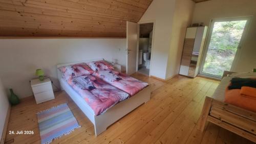 a bedroom with a bed and a wooden floor at Eichberghaus in Aue