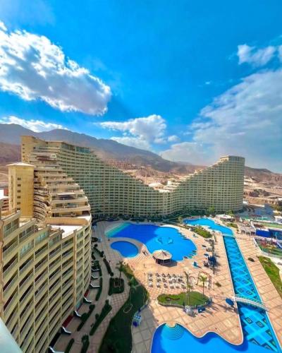 a view of a resort with pools and buildings at بورتو السخنه الاهرامات in Ain Sokhna