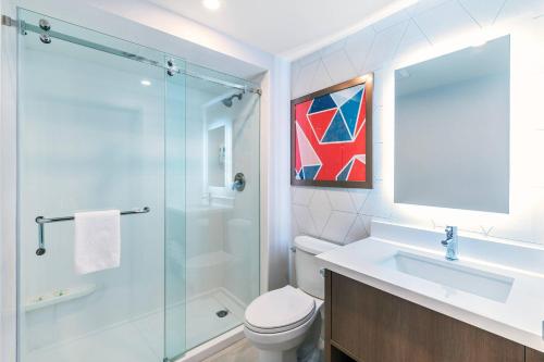 a bathroom with a shower and a toilet and a sink at Comfort Suites in London