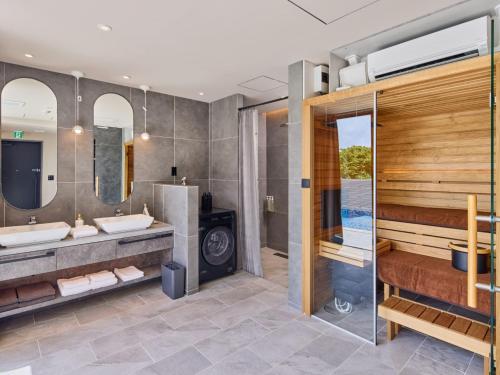 a bathroom with two sinks and a shower at Kandor Resort Okinawa in Nakijin