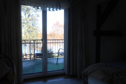 a room with a window with a view of a balcony at Röblinseeterrassen in Fürstenberg-Havel