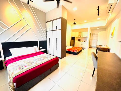 a bedroom with a bed and a table and a kitchen at Chamber Haven KLCC in Kuala Lumpur