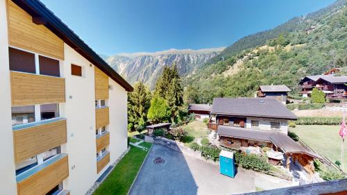 an aerial view of a house with mountains in the background at Haus Belstar B in Naters