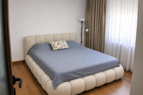 a bed with a pillow on it in a room at Vila Daško in Lukavac