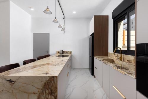 a kitchen with marble countertops and a large island at Katalina Luxury Apartment Eilat in Eilat
