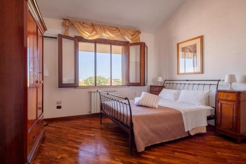 a bedroom with a bed and a large window at Villa Tiffany in Marsala