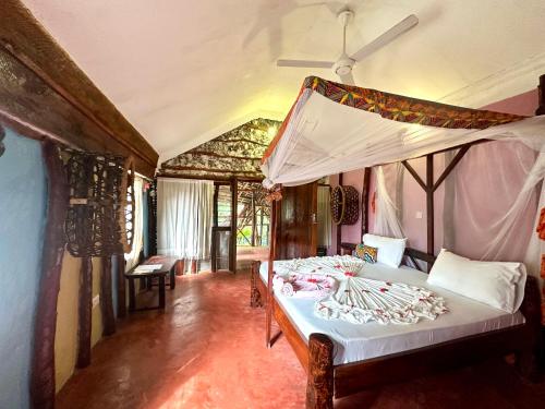 a bedroom with two beds in a room at Mustapha' s Place in Bwejuu