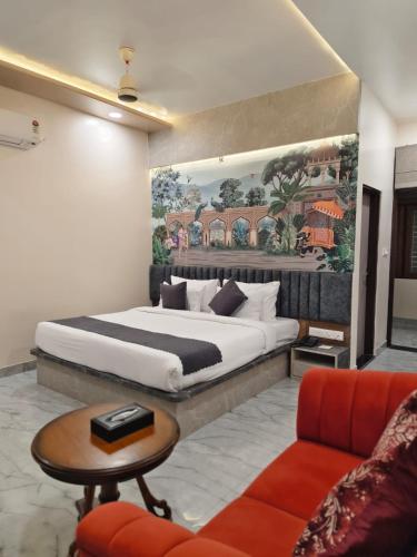 a bedroom with a large bed and a couch at Hotel Sharma Jaipur in Jaipur