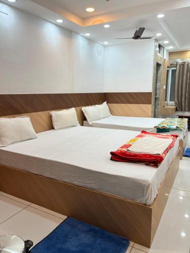 a bedroom with two beds in a room with at Adhunik palace in Keonjhargarh