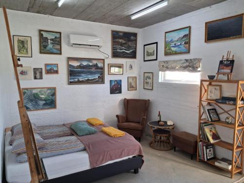 a bedroom with a bed and a chair at Snaefell Apartments in Hellissandur