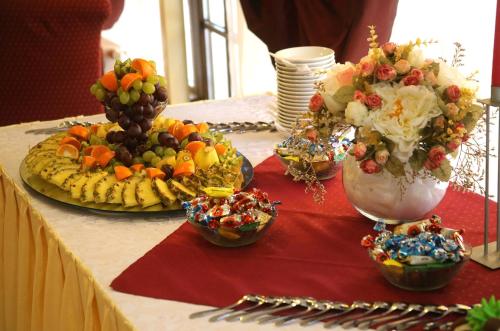 a table with fruit and vegetables in bowls on it at Hotel-Restaurant Smilga in Kėdainiai