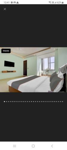 a picture of a bedroom with a bed and a television at Hotel nsb square in Dehradun