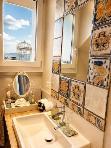 a bathroom with a sink and a mirror at B&B Friedau in Nottwil