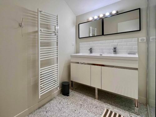 a bathroom with a sink and a mirror at La Serva in Les Lèches