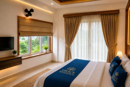 a bedroom with a bed and a tv and a window at Grace Residency in Sultan Bathery