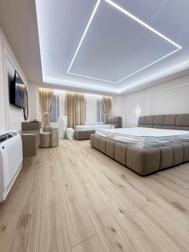a large bedroom with a large bed and a tv at Old Town Inn room 8 in Pogradec