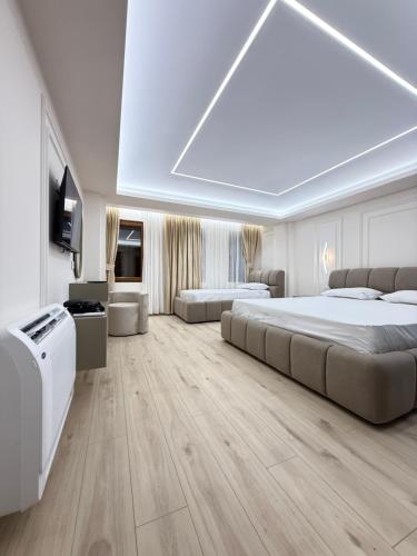 a large bedroom with two beds and a tv at Old Town Inn room 8 in Pogradec
