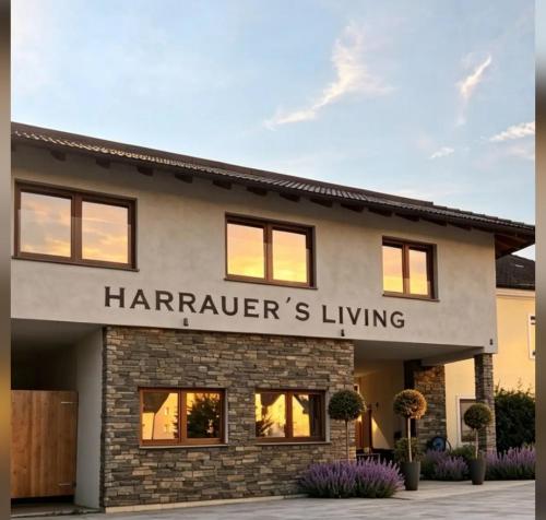 a home with a harrators living sign on it at Landhof Harrauer in Erlauf