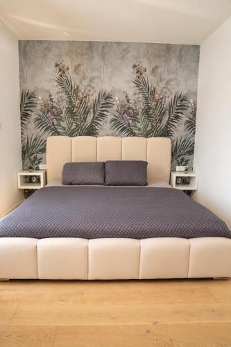 a white bed in a room with a wall at Royal Rest Apartments Karlovac-Luxury, Central Location & Free Parking in Karlovac
