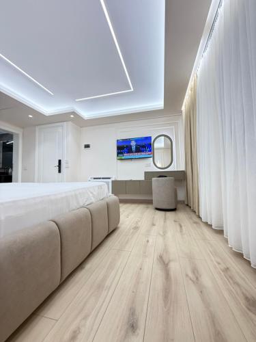 a large bedroom with a large bed and a skylight at Old Town Inn room 9 in Pogradec