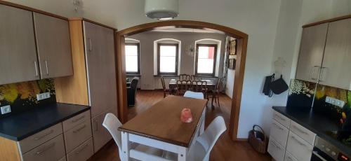 a kitchen with a table and a dining room at Herzstück Ferienwohnung Waxweiler in Waxweiler