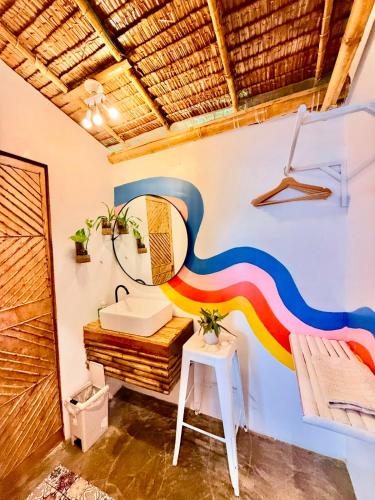 a bathroom with a rainbow painted on the wall at The Kokomo Siargao in General Luna