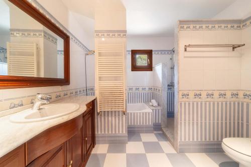 a bathroom with a sink and a toilet at Can Xilla by Sealand Villas in Alcudia