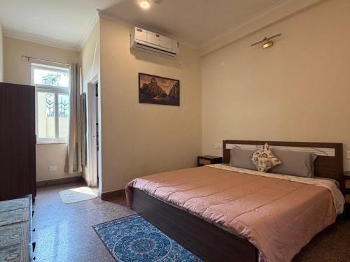 a bedroom with a large bed and a window at The Annexe in Greater Noida