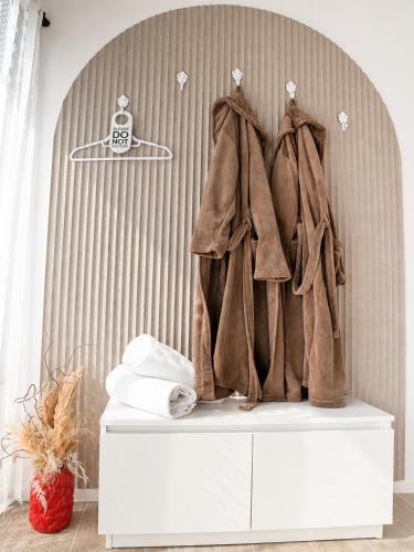 a coat hanging on a dresser in a room at Royal Rest Apartments Karlovac-Luxury, Central Location & Free Parking in Karlovac