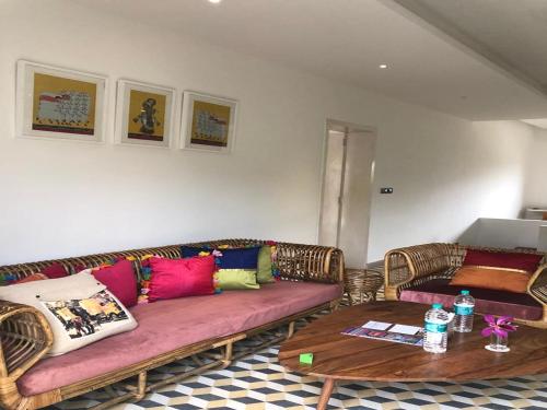 a living room with two couches and a table at DanCenter Parijat Villas & Suites Udaipur in Udaipur