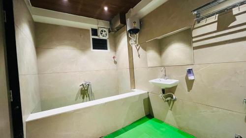 a bathroom with a sink and a bath tub at Hotel Vilaasitaa inn Ujjain in Ujjain