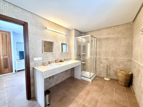 a bathroom with a sink and a shower at Villa Can Alaya in Santa Eularia des Riu