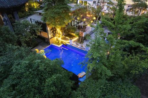 an overhead view of a swimming pool at night at Jade Peak Hot Spring Villa in Dujiangyan