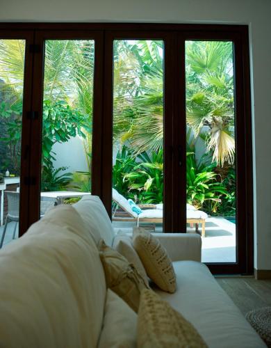 a living room with a white couch and large windows at Okan Chalet in Barka