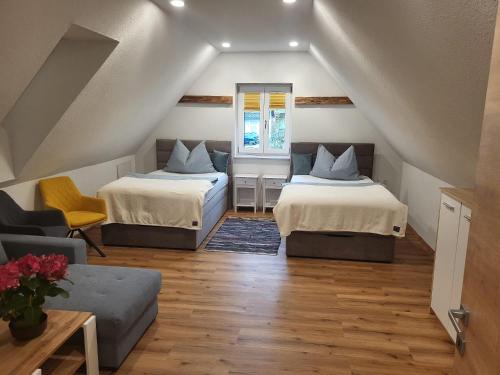 a attic room with two beds and a couch at Ferienhaus Vitabene in Hollenstein an der Ybbs