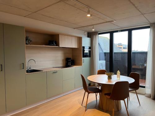 a kitchen and dining room with a table and chairs at Apartment for 4 guests in Bree in Bree