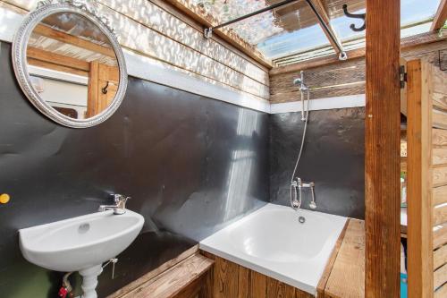 a bathroom with a sink and a mirror at Caravane au jardin in Brix