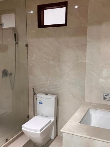 a bathroom with a toilet and a bath tub at Q Kata Residence in Kata Beach