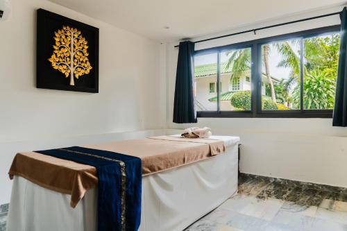 a massage table in a room with a window at The Beach Wellness Residence in Ban Pru Yai