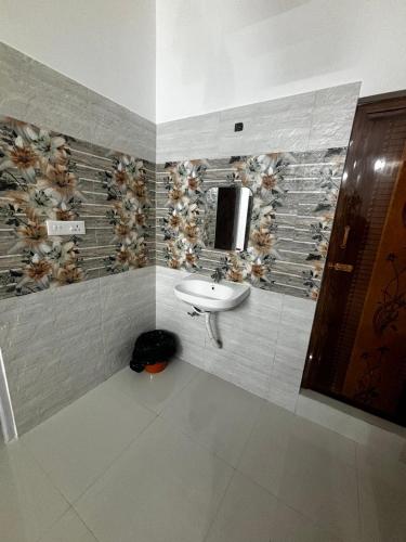 a bathroom with a sink and a mirror at Villa Stay in Pondicherry