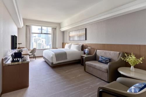 a hotel room with a bed and a couch at Hopewell Hotel in Hong Kong