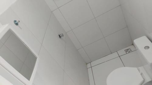 a white bathroom with a shower and a toilet at POUSADA BRISA do FUTURO in Fortaleza