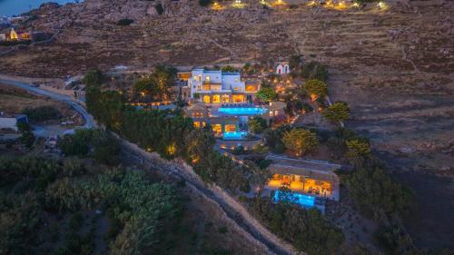 an aerial view of a house on a hill at night at Primadonna Luxury Villas in Mikonos