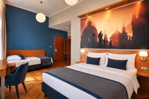 a hotel room with two beds and a desk at Hotel Adler - Czech Leading Hotels in Prague