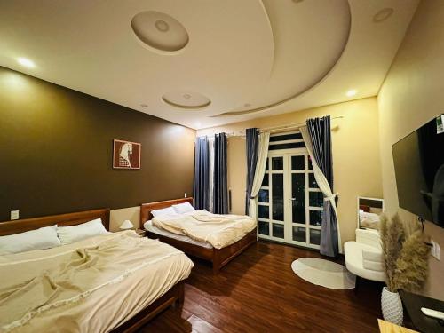 a hotel room with two beds and a window at Phố Homestay TĐT in Ấp Tân An (1)